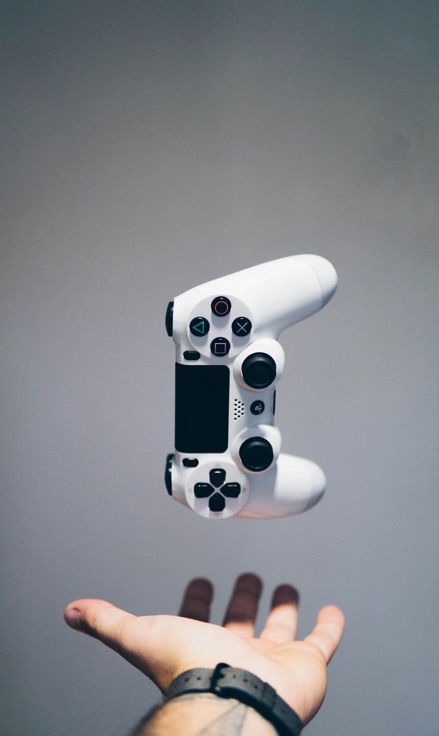White game controller floating against a grey background